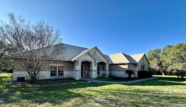 14356 Retablo, Helotes, TX 78023 - view of front facade with a standing seam roof, metal roof, and a front yard