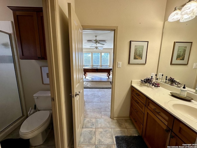14356 Retablo, Helotes, TX 78023 - bathroom featuring vanity, toilet, a shower stall, a ceiling fan, and tile patterned flooring