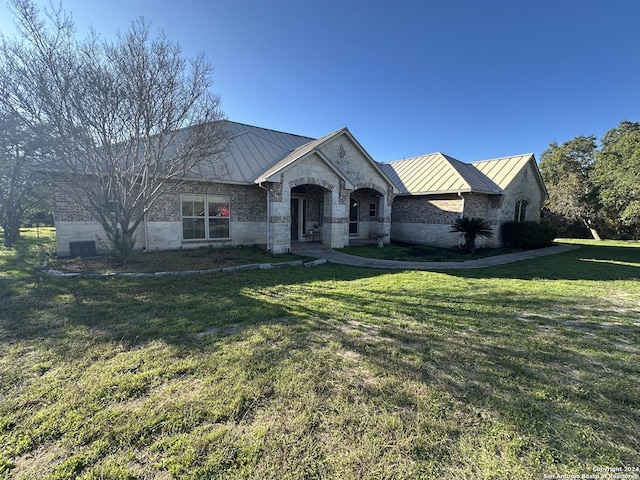 14356 Retablo, Helotes, TX 78023 - view of front facade with a standing seam roof, metal roof, and a front lawn
