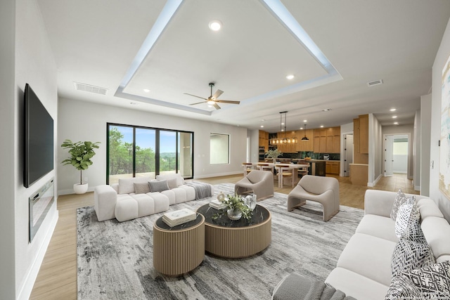 25822 Mount Carillon, San Antonio, TX 78260 - living area featuring a raised ceiling, baseboards, recessed lighting, ceiling fan, and light wood-style flooring