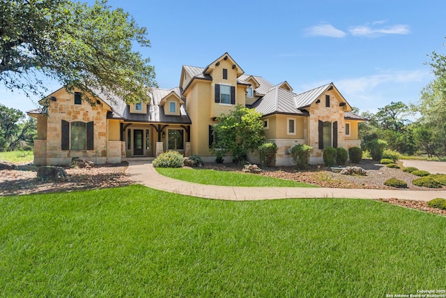 102 Arroyo, Boerne, TX 78006 - view of front of property featuring a standing seam roof, stone siding, metal roof, and a front lawn