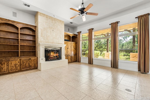 102 Arroyo, Boerne, TX 78006 - unfurnished living room featuring light tile patterned flooring, a fireplace, a ceiling fan, and baseboards