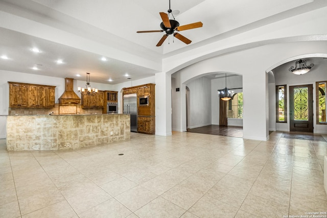 102 Arroyo, Boerne, TX 78006 - unfurnished living room featuring a chandelier, light tile patterned floors, recessed lighting, arched walkways, and ceiling fan