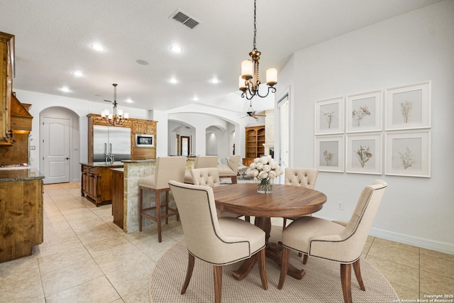 102 Arroyo, Boerne, TX 78006 - dining area with arched walkways, a chandelier, light tile patterned floors, recessed lighting, and baseboards