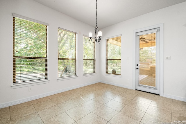 102 Arroyo, Boerne, TX 78006 - unfurnished dining area featuring healthy amount of natural light, light tile patterned flooring, a chandelier, and baseboards