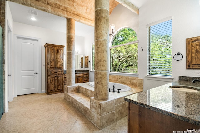 102 Arroyo, Boerne, TX 78006 - full bathroom featuring ornate columns, two vanities, a garden tub, and tile patterned floors