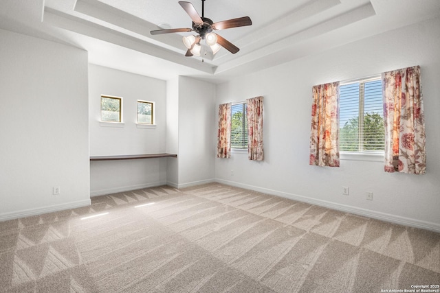 102 Arroyo, Boerne, TX 78006 - unfurnished room with a tray ceiling, carpet floors, healthy amount of natural light, and a ceiling fan