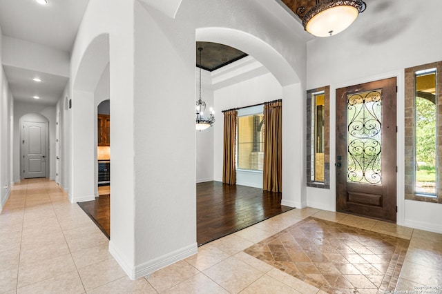 102 Arroyo, Boerne, TX 78006 - foyer entrance featuring inlaid floor details, arched walkways, baseboards, and recessed lighting