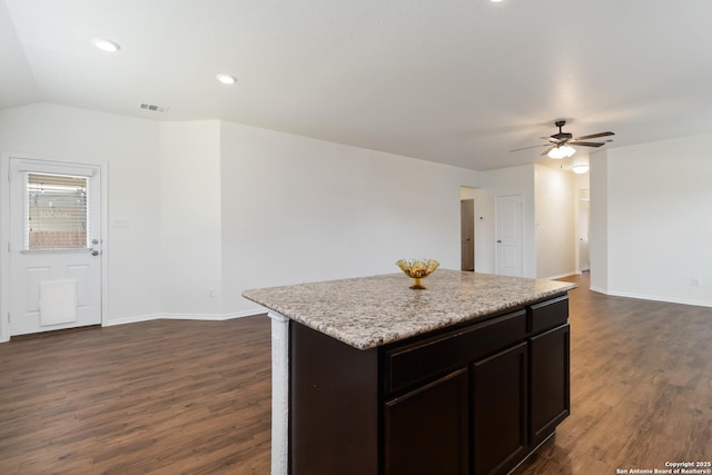 kitchen featuring ceiling fan, dark wood-type flooring, a kitchen island, baseboards, and recessed lighting