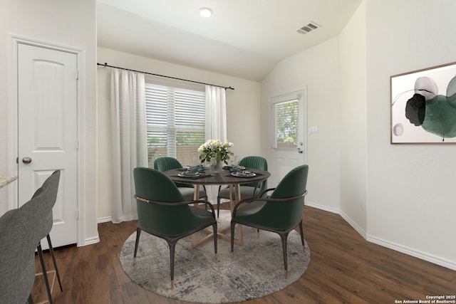 dining area with vaulted ceiling, baseboards, and dark wood-type flooring