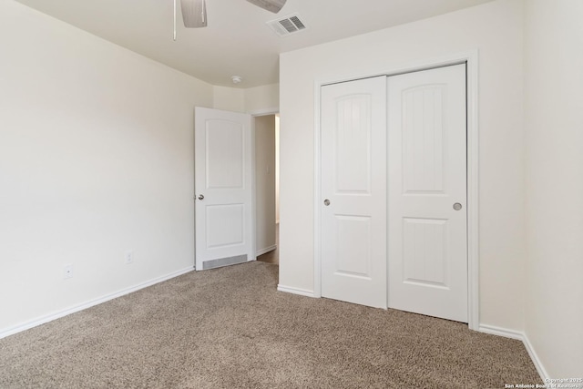 unfurnished bedroom with carpet floors, a closet, baseboards, and a ceiling fan