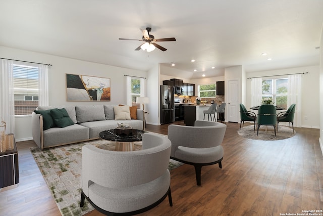 living area featuring a ceiling fan, recessed lighting, wood finished floors, and baseboards