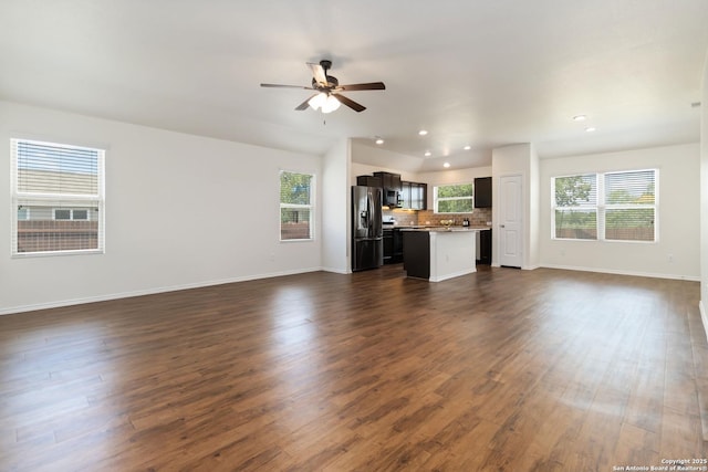unfurnished living room with a ceiling fan, baseboards, dark wood-type flooring, and recessed lighting