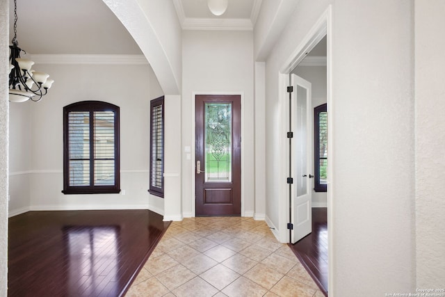 19015 Seminole Pass, Garden Ridge, TX 78266 - entryway with arched walkways, healthy amount of natural light, a chandelier, light wood-type flooring, and ornamental molding