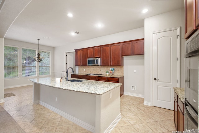 19015 Seminole Pass, Garden Ridge, TX 78266 - kitchen with stainless steel appliances, a sink, light tile patterned flooring, a chandelier, and decorative backsplash