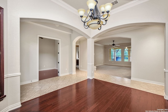 19015 Seminole Pass, Garden Ridge, TX 78266 - tiled empty room featuring arched walkways, a chandelier, ceiling fan, ornamental molding, and baseboards