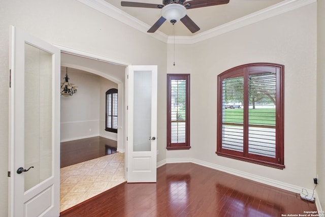 19015 Seminole Pass, Garden Ridge, TX 78266 - unfurnished room with arched walkways, crown molding, wood finished floors, a ceiling fan, and french doors