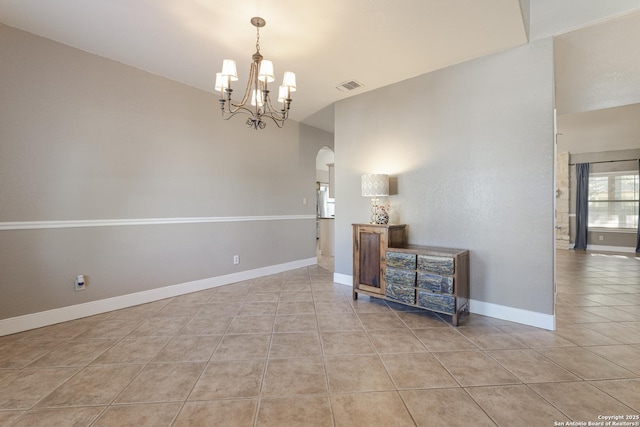 212 Leather Leaf, Boerne, TX 78006 - empty room with light tile patterned floors, arched walkways, a chandelier, and baseboards