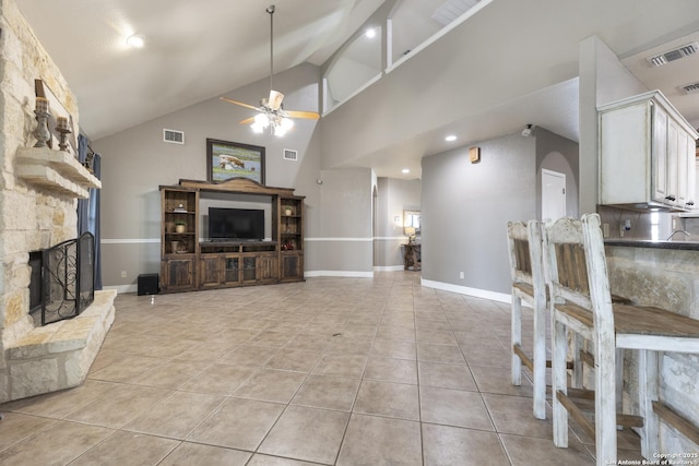 212 Leather Leaf, Boerne, TX 78006 - living area with a stone fireplace, ceiling fan, light tile patterned flooring, high vaulted ceiling, and recessed lighting
