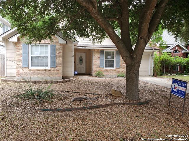 4218 Swan Frst, San Antonio, TX 78222 - view of front of house with brick siding, concrete driveway, and a garage