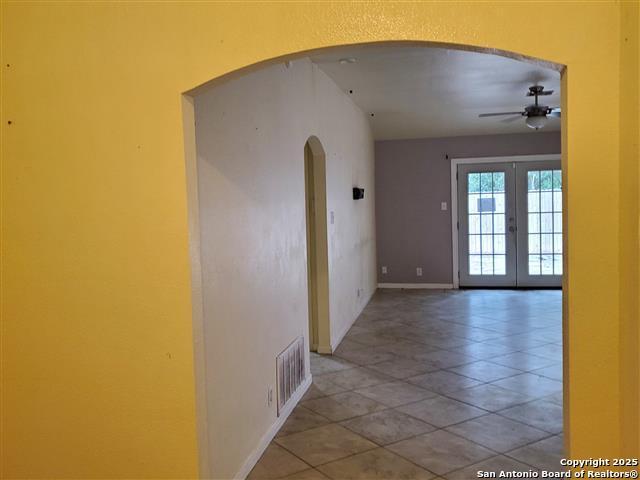 4218 Swan Frst, San Antonio, TX 78222 - corridor featuring arched walkways, french doors, and baseboards