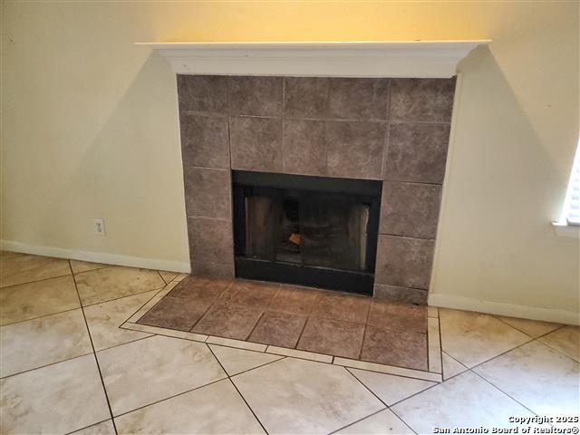4218 Swan Frst, San Antonio, TX 78222 - detailed view of a tile fireplace and baseboards