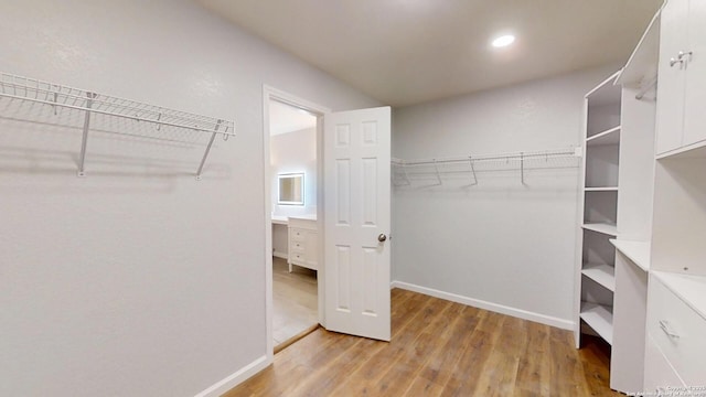 walk in closet featuring light wood finished floors