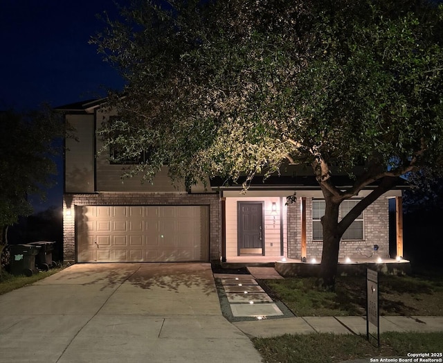 obstructed view of property featuring driveway and brick siding