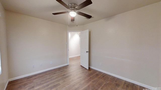 unfurnished room with baseboards, ceiling fan, and wood finished floors