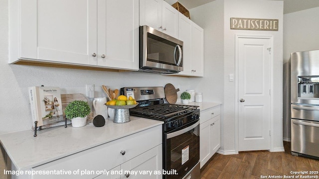 5026 Wichita Pike, San Antonio, TX 78253 - kitchen with appliances with stainless steel finishes, dark wood finished floors, white cabinetry, and light stone counters