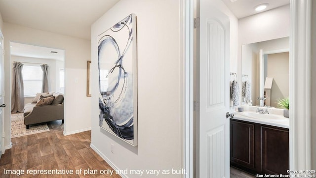 7314 Perseus Brk, San Antonio, TX 78252 - hallway with a sink, wood finished floors, and baseboards