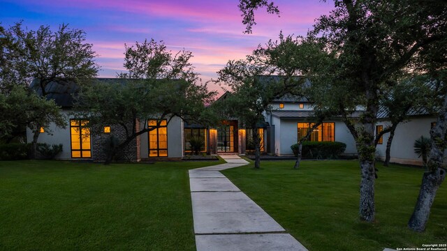 185 Southfield, Boerne, TX 78006 - view of front of home featuring a standing seam roof, a yard, stucco siding, and metal roof