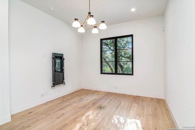 185 Southfield, Boerne, TX 78006 - empty room featuring light wood-style floors, a chandelier, baseboards, and recessed lighting