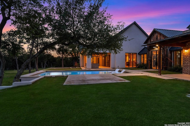 185 Southfield, Boerne, TX 78006 - pool at dusk featuring a patio area, a lawn, and an outdoor pool