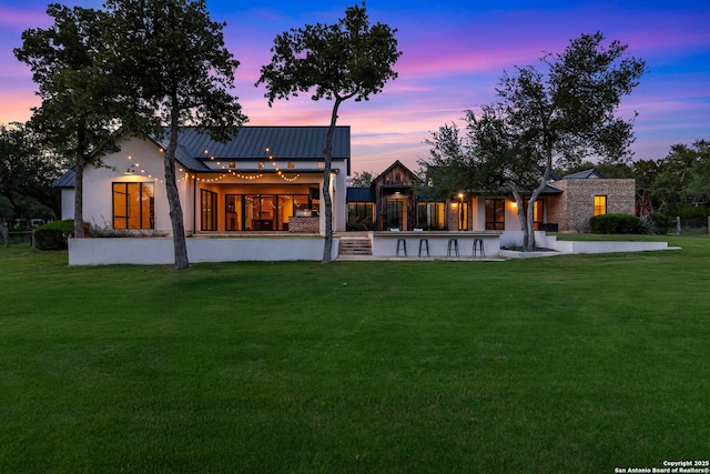185 Southfield, Boerne, TX 78006 - rear view of house featuring a yard, a standing seam roof, stucco siding, and metal roof