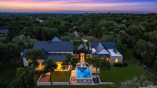 185 Southfield, Boerne, TX 78006 - aerial view at dusk of a wooded view and view of pool area