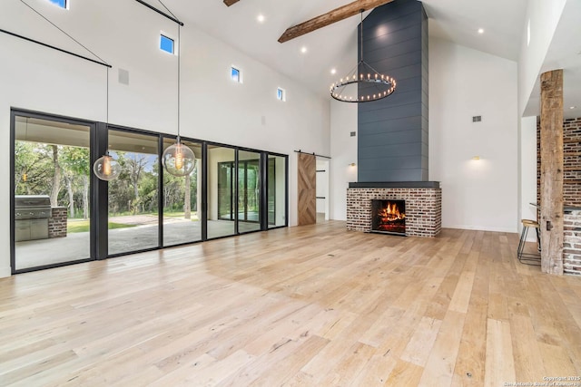 185 Southfield, Boerne, TX 78006 - unfurnished living room with high vaulted ceiling, hardwood / wood-style flooring, a fireplace, beam ceiling, and a chandelier