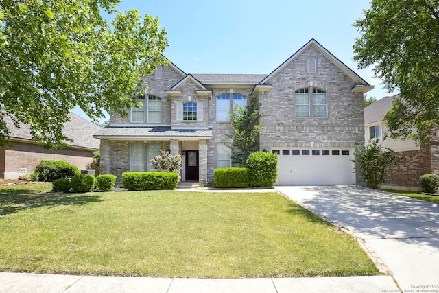traditional-style home with concrete driveway, a front yard, an attached garage, and brick siding