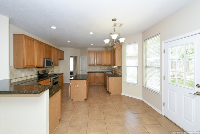 kitchen featuring stainless steel appliances, backsplash, a chandelier, light tile patterned floors, and recessed lighting