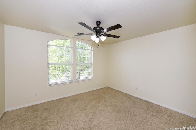 spare room with light colored carpet and baseboards
