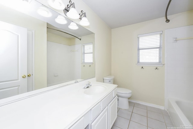 bathroom featuring tile patterned floors, toilet, vanity, bathtub / shower combination, and baseboards