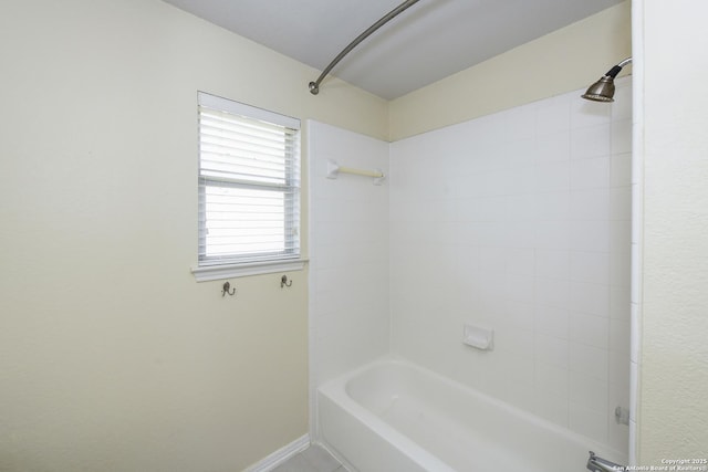 bathroom with baseboards and tub / shower combination