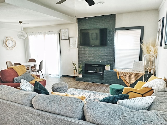 6346 Montgomery, Windcrest, TX 78239 - living area featuring wood finished floors, a ceiling fan, and a brick fireplace