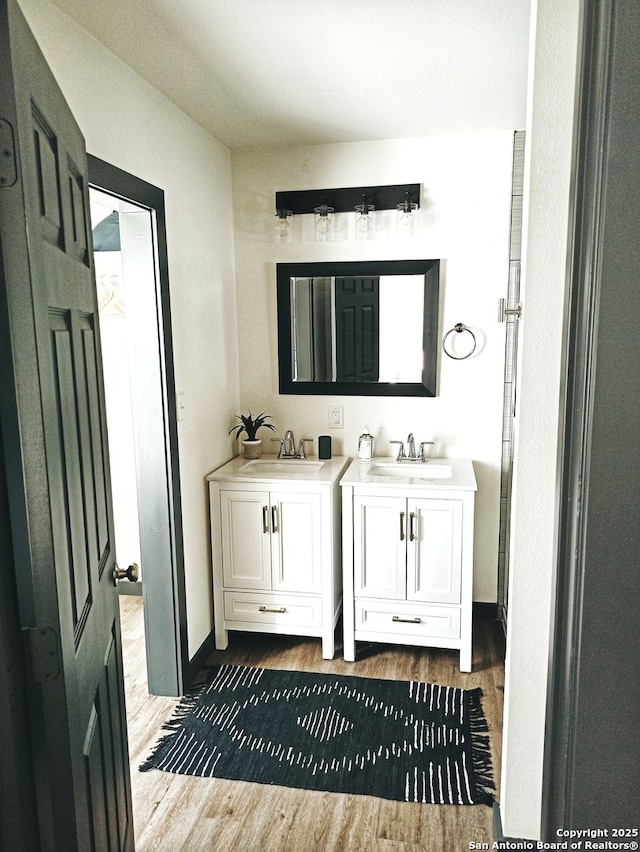 6346 Montgomery, Windcrest, TX 78239 - bathroom featuring wood finished floors and vanity