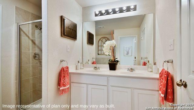 12123 Jasper Strm, San Antonio, TX 78245 - bathroom featuring a shower stall and double vanity