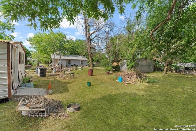 3742 Weir Ave, San Antonio, TX 78226 - view of green lawn with an outdoor structure and a storage unit