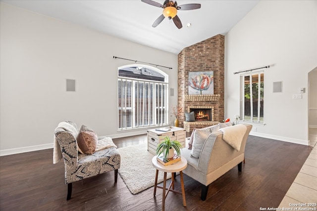 12627 Alamito Crk, San Antonio, TX 78254 - living room with a fireplace, ceiling fan, wood finished floors, baseboards, and high vaulted ceiling