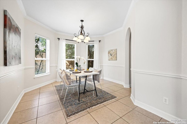 12627 Alamito Crk, San Antonio, TX 78254 - dining room with light tile patterned floors, a chandelier, ornamental molding, baseboards, and arched walkways