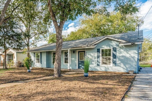 827 Ware Blvd, San Antonio, TX 78214 - ranch-style house with fence, a shingled roof, and covered porch
