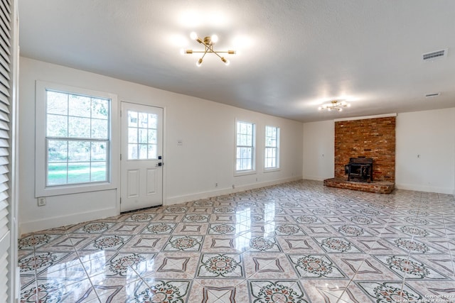 827 Ware Blvd, San Antonio, TX 78214 - unfurnished living room with baseboards, light tile patterned floors, and a chandelier